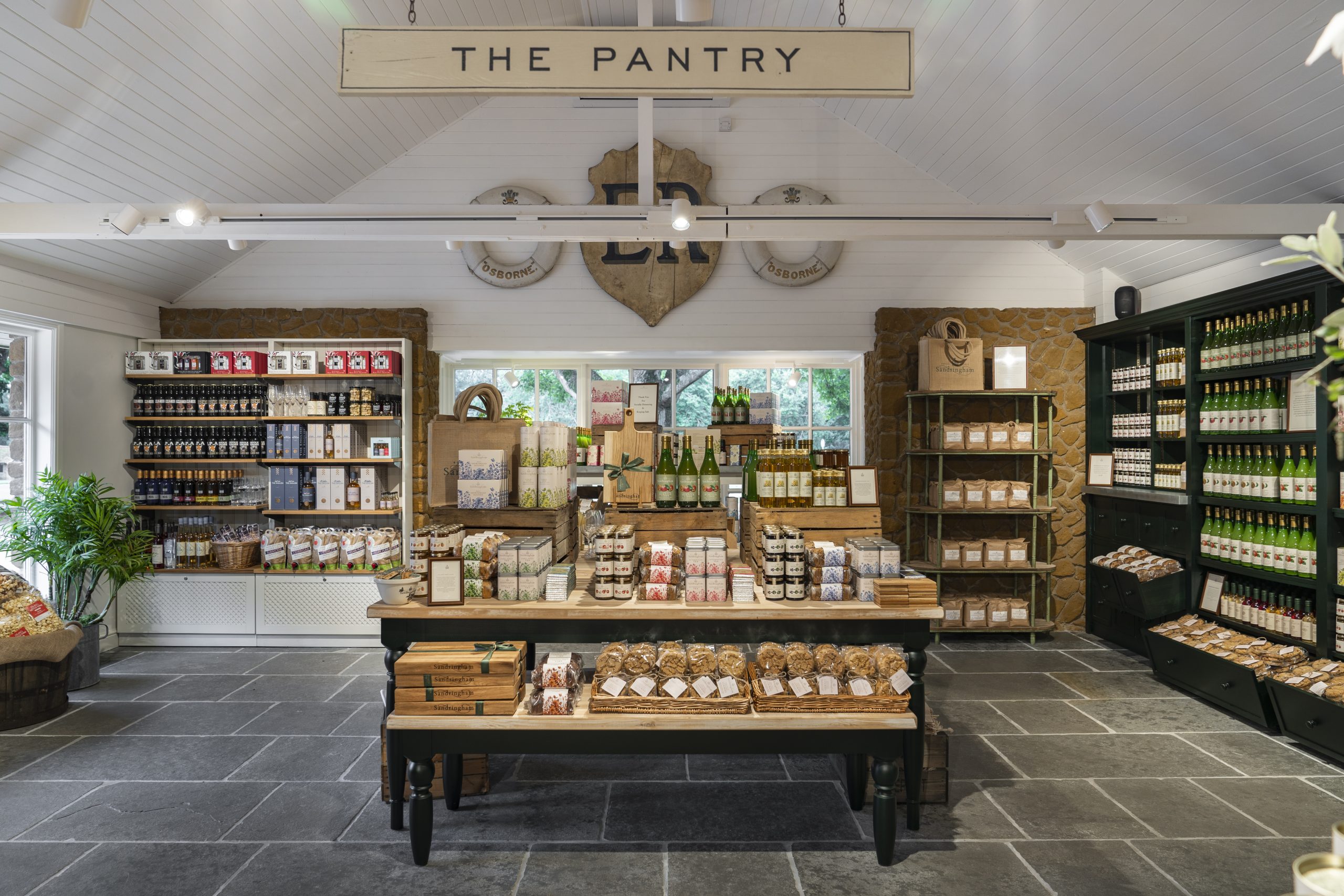 A table and shelves in side the shop with Sandringham produce