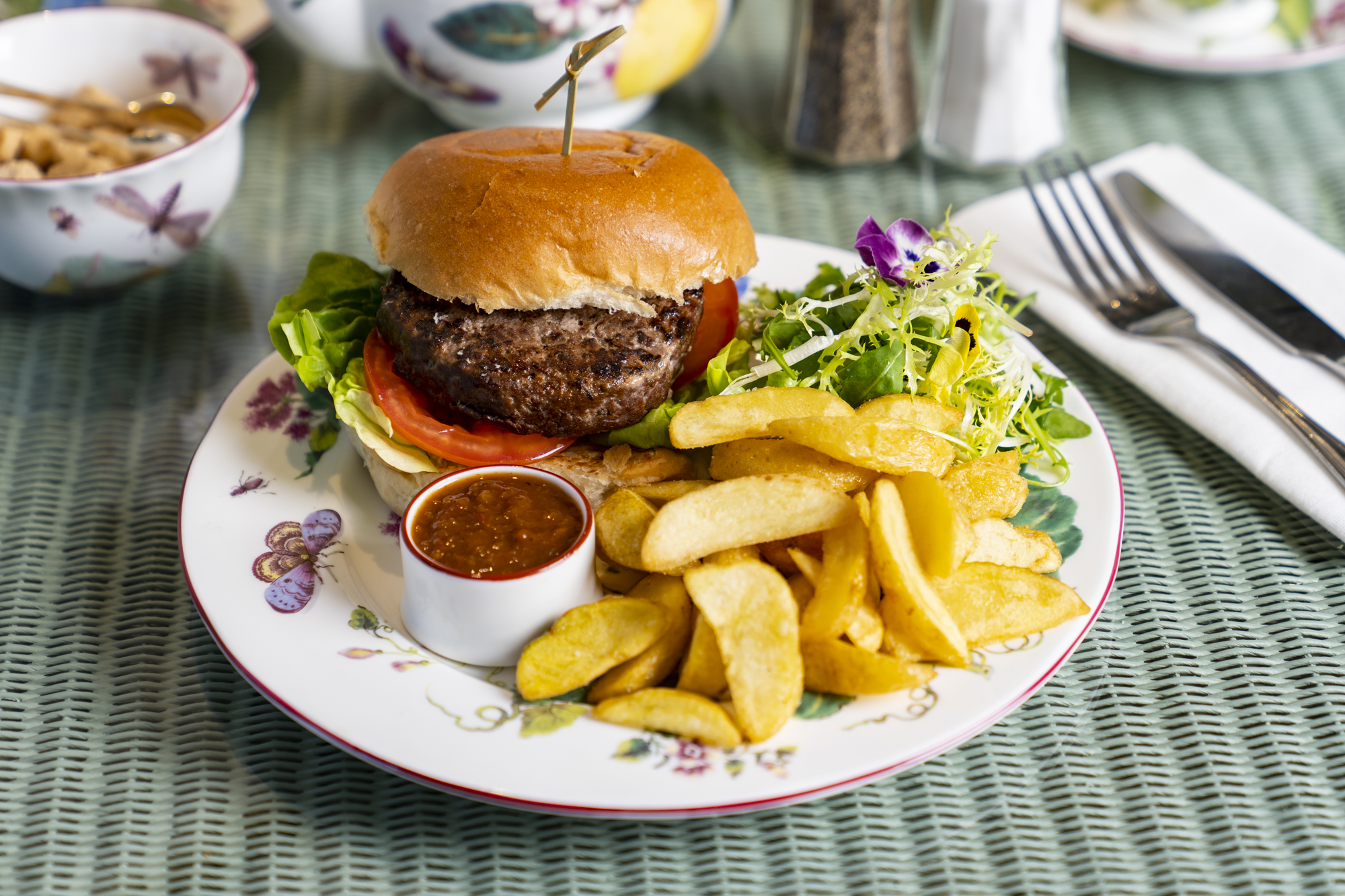 A burger made from meat reared on the Estate with a side salad and chips