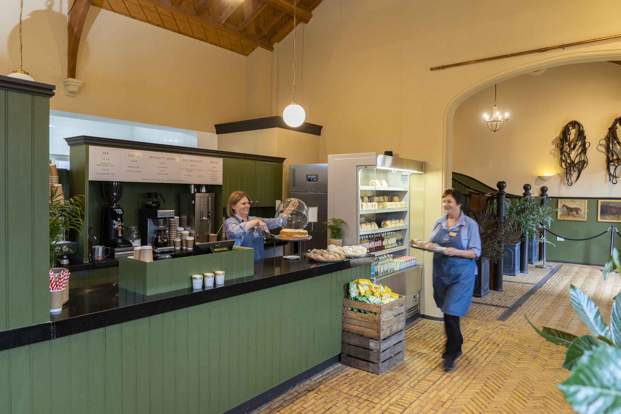 An image of a green counter with sandwiches and cakes at a takeaway cafe